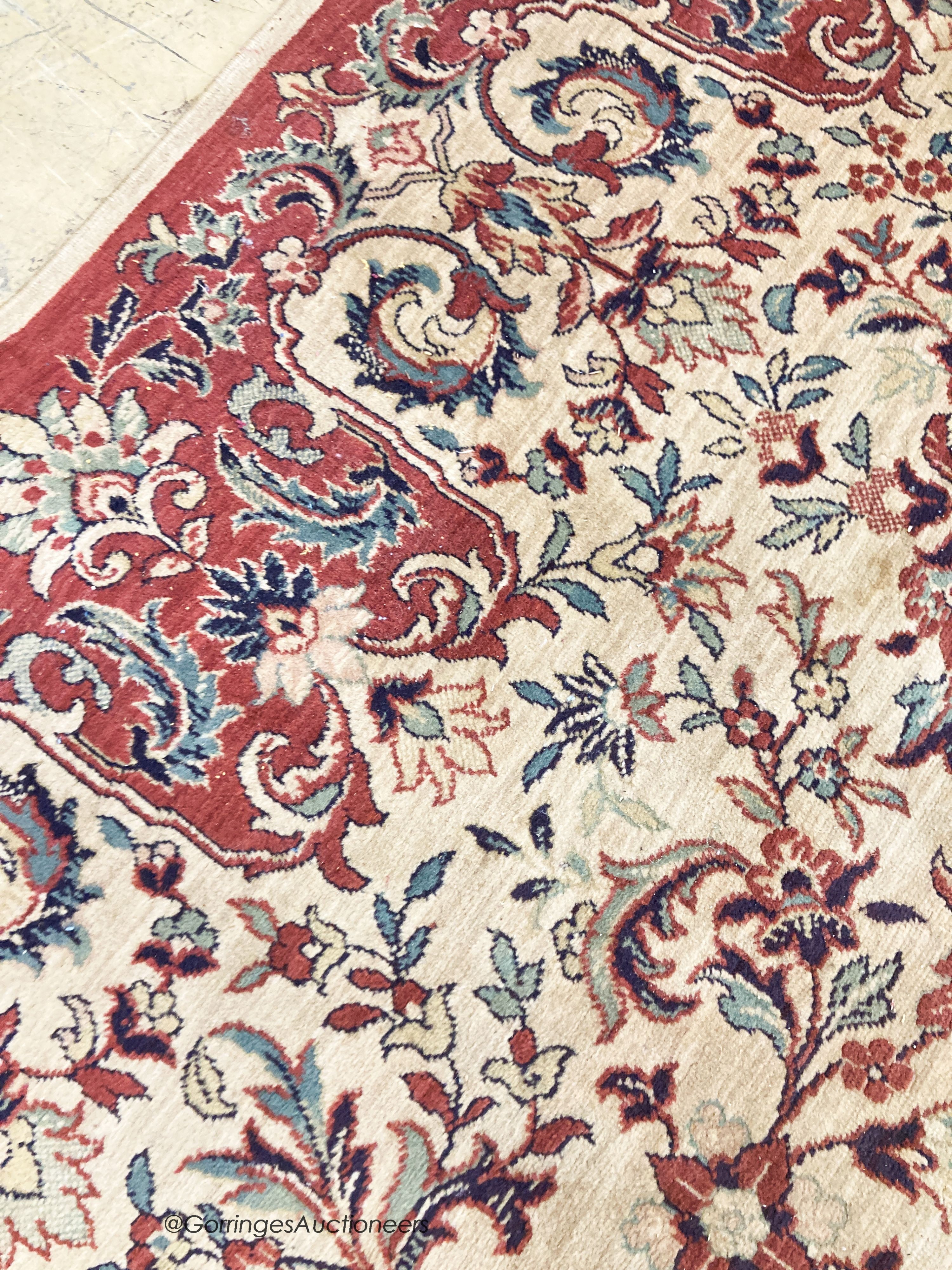 A Persian style ivory ground carpet, 380 x 280cm